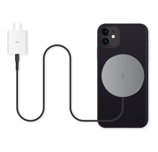 Graphite grey MagSafe compatible fast-charging magnetic charger with built-in 1.5m USB-C cable charging a black iPhone 12 